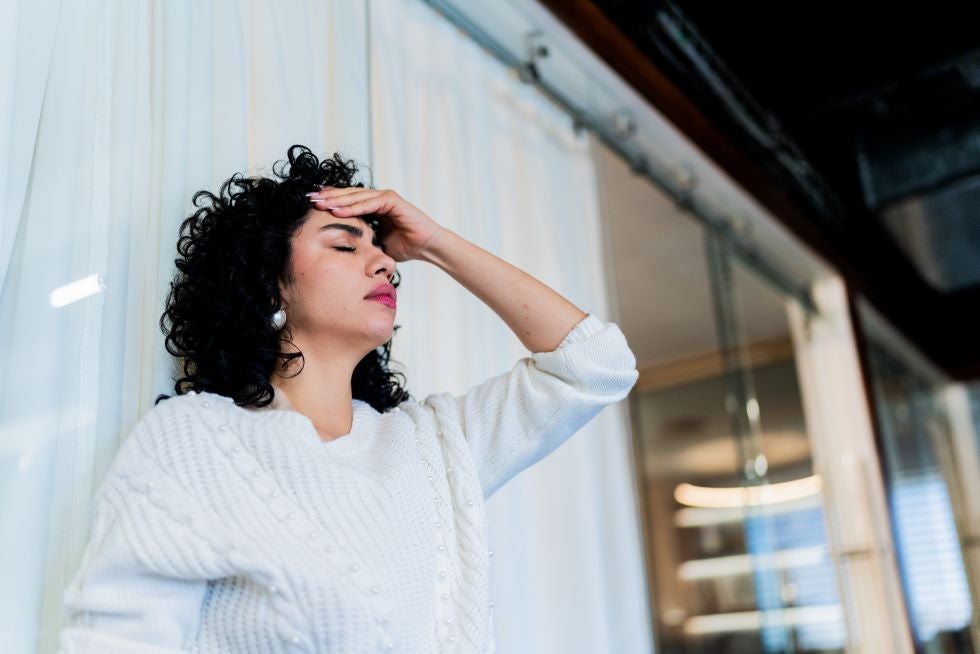Woman with closed eyes having a dizzy spell